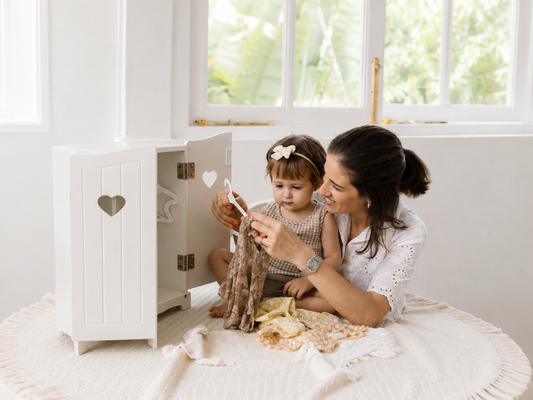 Happy parents packing infant luggage for travel